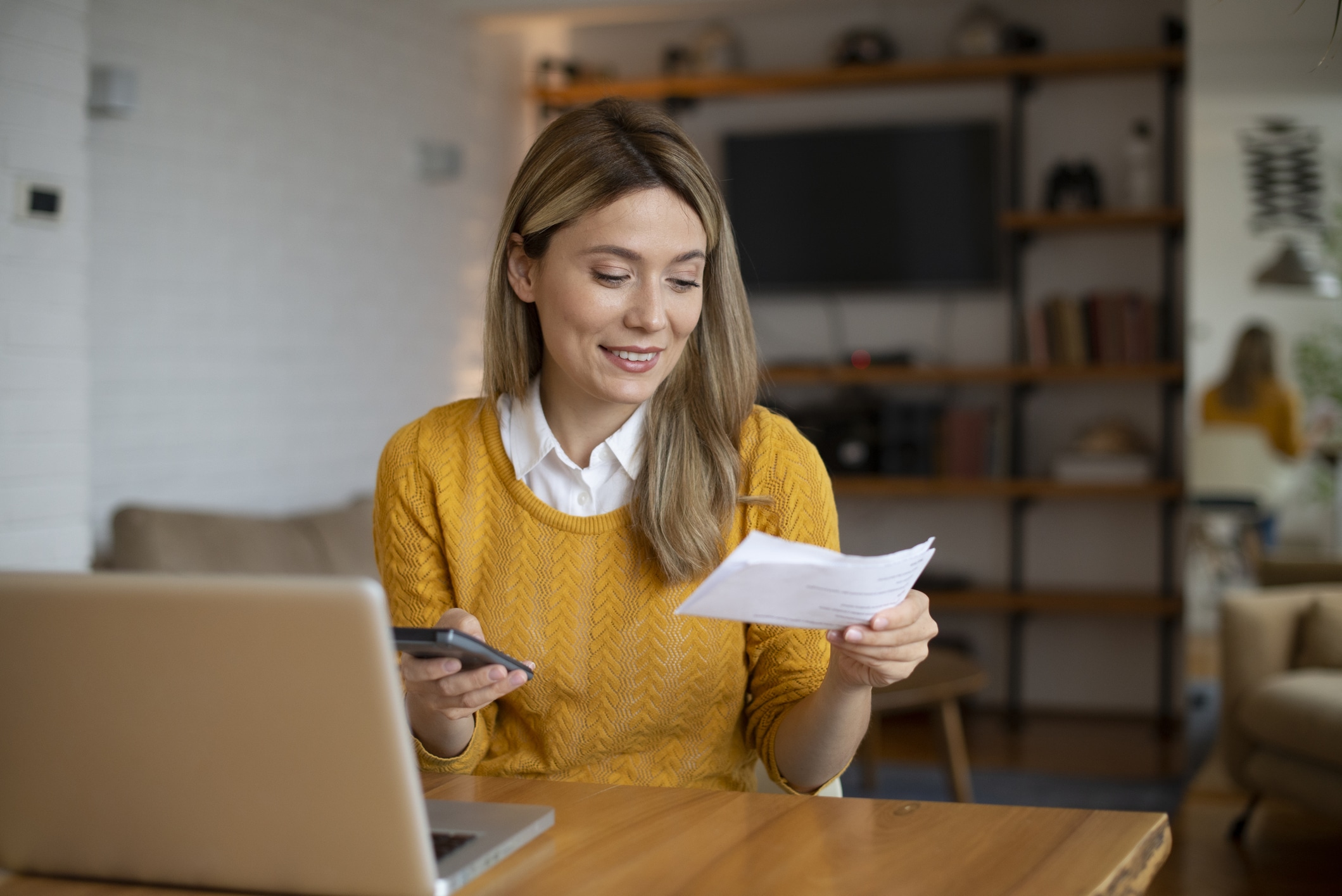 Woman planning home budget and using calculator stock photo
