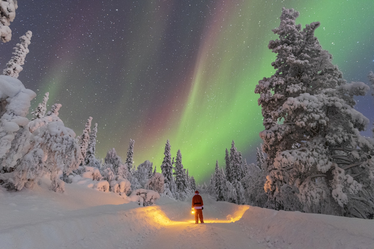 Santa Claus admiring northern lights donde viajar para ver auroras boreales